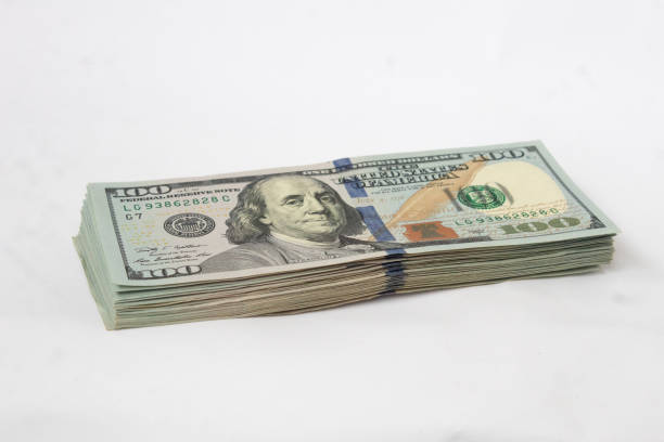 istock A wad of dollars on a white isolated background. Hundred-dollar bills in one bundle 1333436460