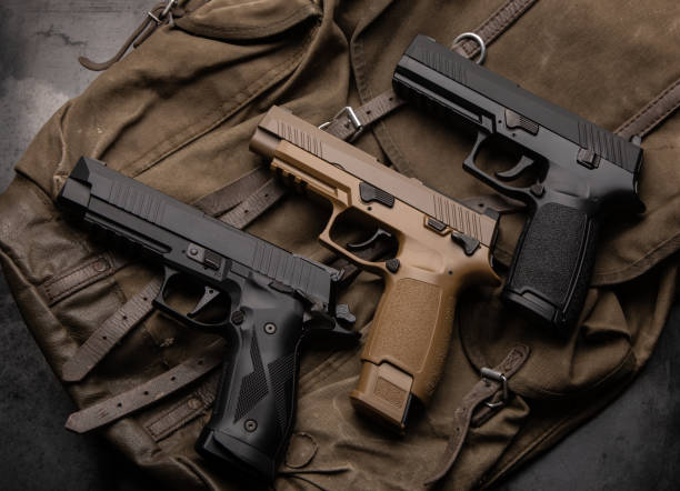 istock Several modern air pistols on a vintage canvas backpack. Non-lethal weapons for sports and entertainment. 1333437290