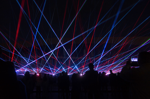 blue laser lights and people silhouettes at concert