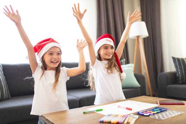 istock Two Beautiful Sisters making Christmas cards. christmas concept background. 1333440410