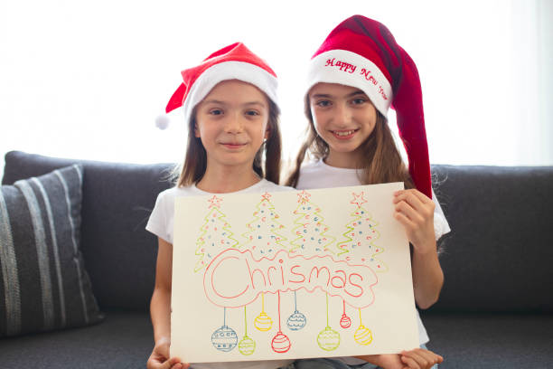 istock Two Beautiful Sisters making Christmas cards. christmas concept background. 1333440417
