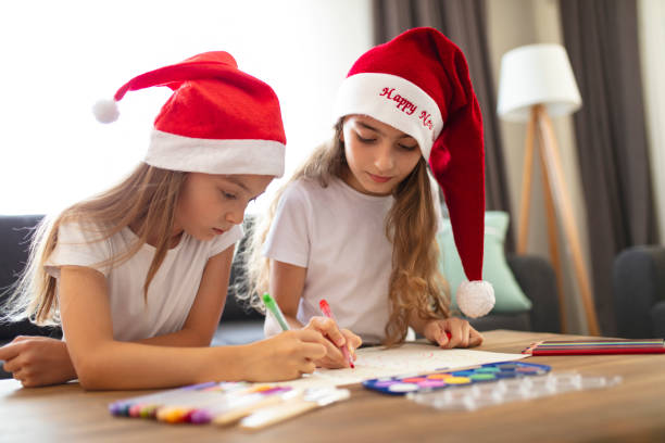 istock Two Beautiful Sisters making Christmas cards. christmas concept background. 1333440421
