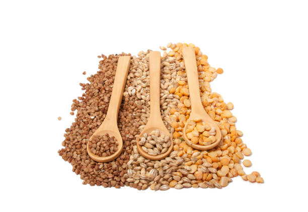 istock Wooden spoon with grain on the white 1333441818