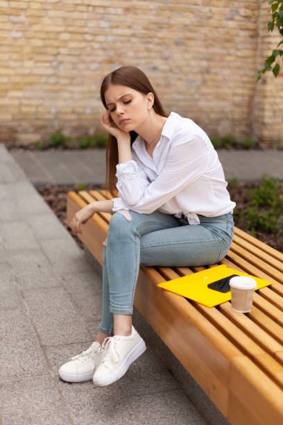 istock Upset young woman sits outdoors. Headache and burnout 1333443447