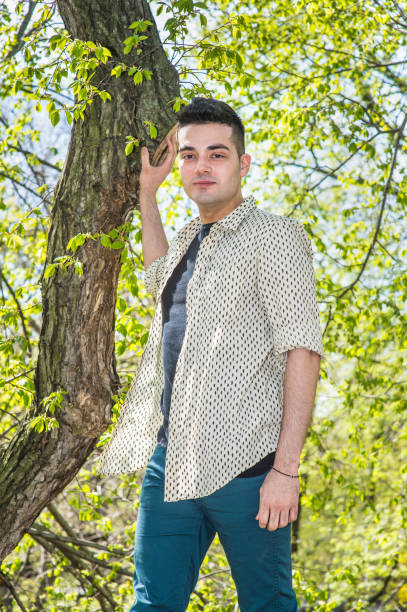 istock Young man standing by trees in spring in New York City, looking forward 1333443766