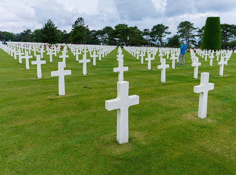 Military headstones honoring armed forces servicemen decorated with American flags for Memorial Day