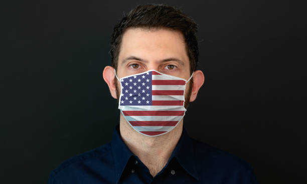 istock Man wearing American flag protective medical face mask. 1333445764