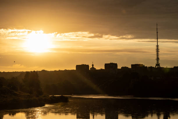 istock Warm sunrise view in city with reflection in lake 1333447919