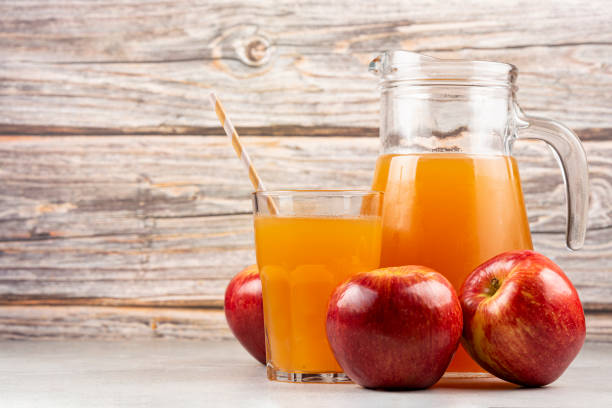 istock Apple juice and red apples on the table. 1333448872