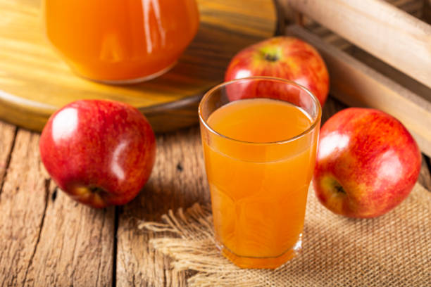 istock Apple juice and red apples on the table. 1333448881
