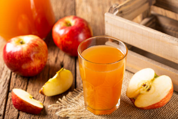 istock Apple juice and red apples on the table. 1333448884