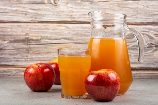 istock Apple juice and red apples on the table. 1333448887