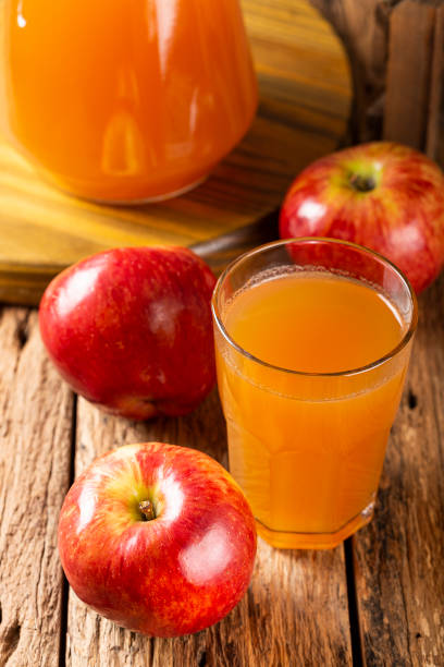 istock Apple juice and red apples on the table. 1333448896