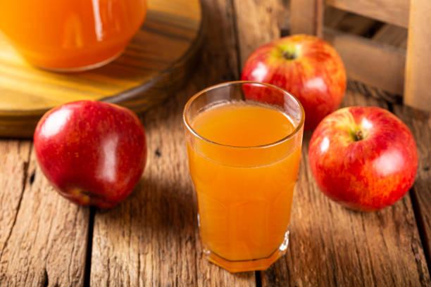 istock Apple juice and red apples on the table. 1333448897