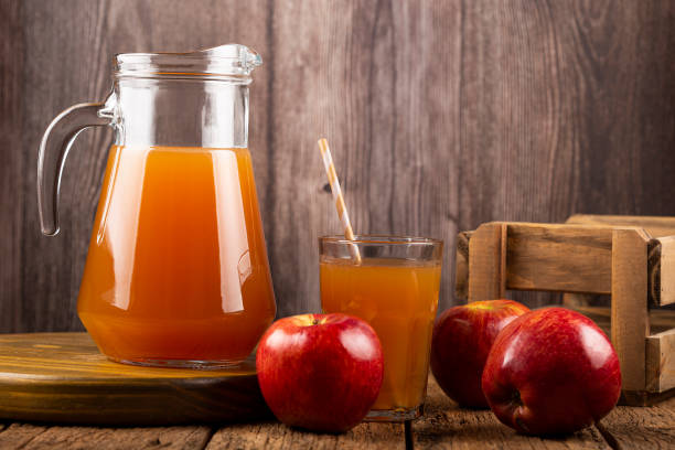 istock Apple juice and red apples on the table. 1333448903