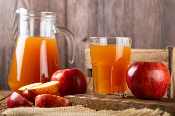 istock Apple juice and red apples on the table. 1333448940