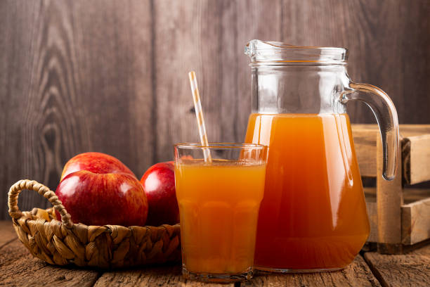 istock Apple juice and red apples on the table. 1333448949