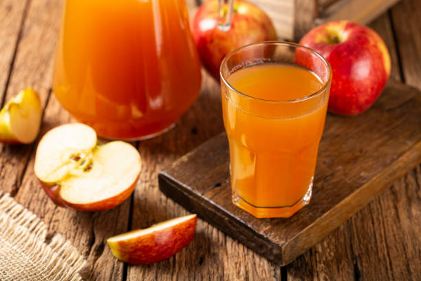 istock Apple juice and red apples on the table. 1333448956
