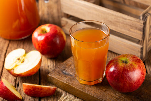 istock Apple juice and red apples on the table. 1333448960