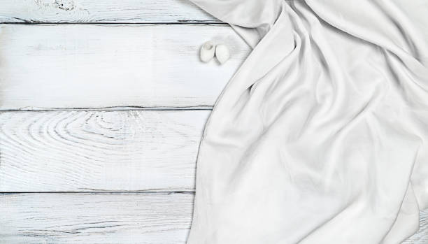 istock White silk fabric on white wooden background 1333451166