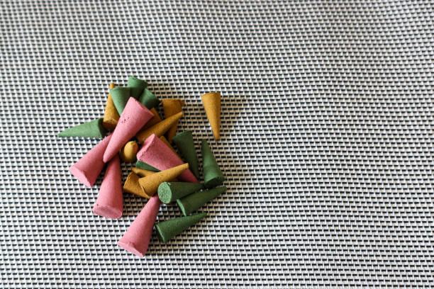 Various color and scent of cone incense on the silver place mat.