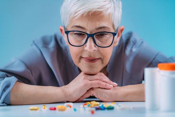 istock Senior patient counting pills. Medicine non-adherence. 1333455911