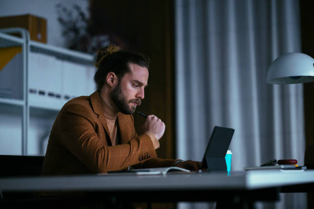 istock Handsome Businessman is Sitting in the Office Working Overtime 1333458137