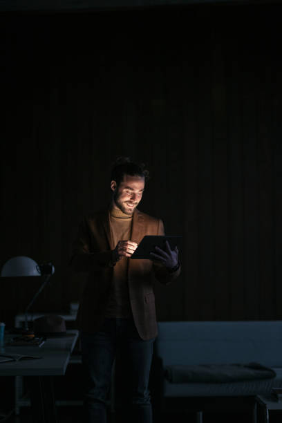 istock Handsome Businessman Working Overtime, Standing in his Office Using the Tablet 1333458156