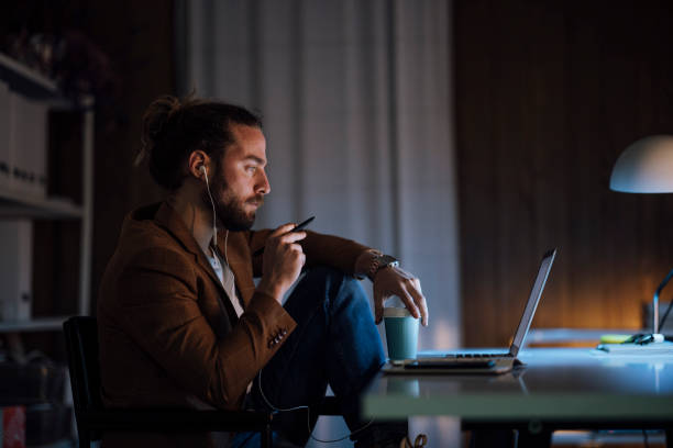 istock Handsome Businessman Holding a Coffee Cup and Pen While Having a Video Call over his Laptop 1333458197