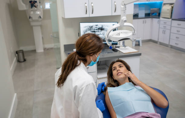 istock Woman with a toothache visiting the dentist 1333458336