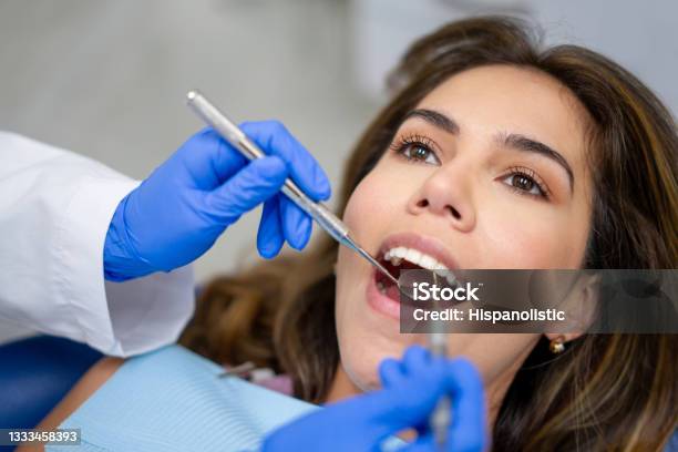 Patient At The Dentist Getting Her Teeth Cleaned Stock Photo - Download Image Now - Periodontal Disease, Dental Health, Dental Equipment