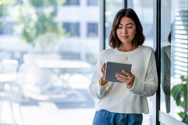 istock Young business woman using a digital tablet 1333461476
