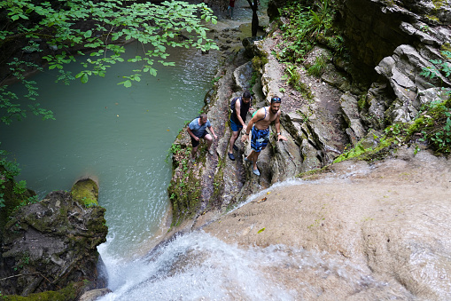 Three friends are trekking on the challenging waterfall path, Erfelek Waterfall, Sinop