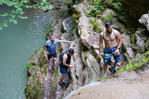 Three friends are trekking on the challenging waterfall path, Erfelek Waterfall, Sinop