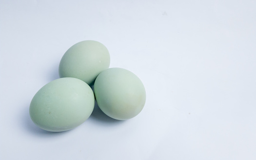 three duck eggs laying on white background