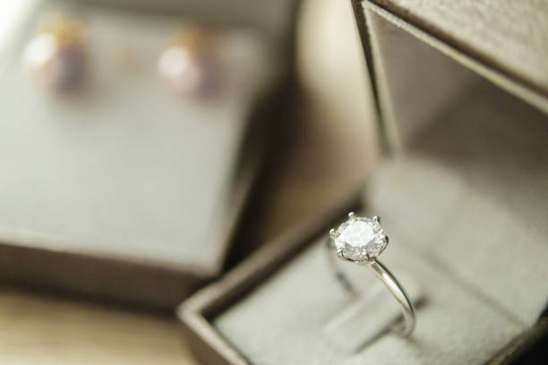 istock Diamond ring in jewelry gift box on wood table 1333469691
