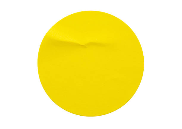 istock Yellow round paper sticker label isolated on white background 1333469906