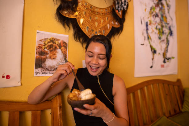 インドネシア料理店でデザートを食べるアジア人女性 - women eating ice cream indigenous culture ストックフォトと画像