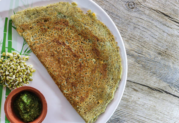 Dosa is basically a South Indian dish which is crepe or thin crispy chilla type pancake. Ideally dosa is made up from urad dal n rice fermented better. stock photo