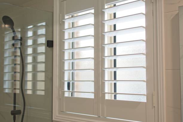 Plantation shutters Luxury plantation shutters in bathroom shutter stock pictures, royalty-free photos & images