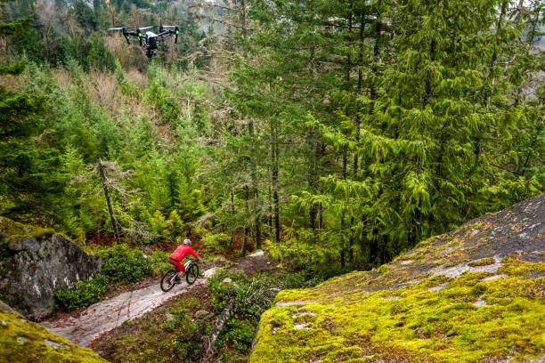 istock View of mountain biker riding down rock slab in forest 1333495237