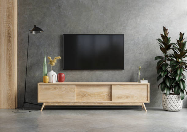 istock Mockup a TV wall mounted in a dark room with concrete wall. 1333496106