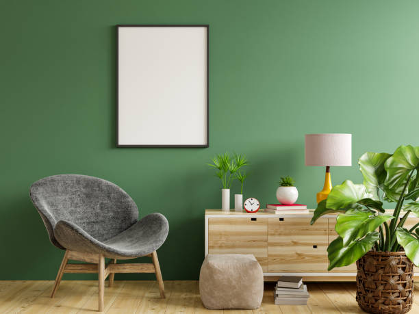 istock Poster mockup with vertical frame on empty green wall in living room interior with gray velvet armchair. 1333496129