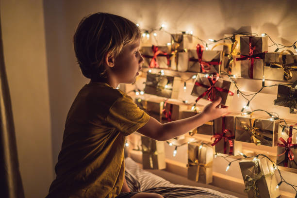 istock The boy opens a gift from the advent calendar 1333497732
