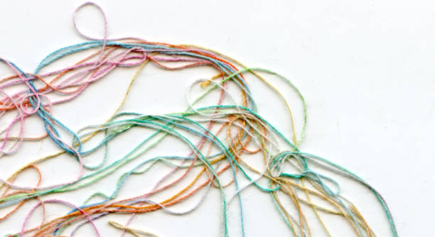 istock Multicolor tangled color needlecraft silk cord. Abstract color background, in white background 1333499975