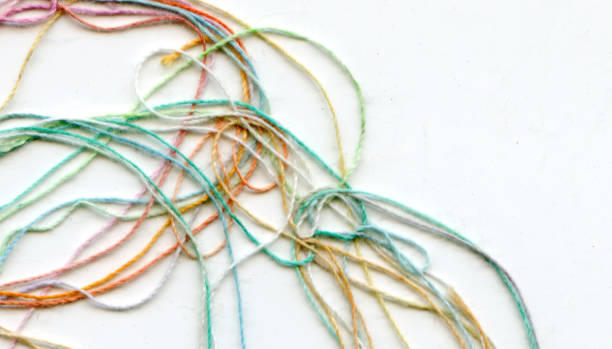 istock Multicolor tangled color needlecraft silk cord. Abstract color background, in white background 1333499982