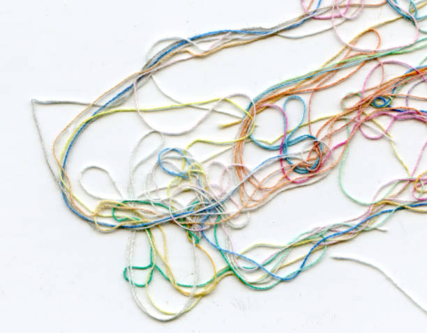 istock Multicolor tangled color needlecraft silk cord. Abstract color background, in white background 1333499995