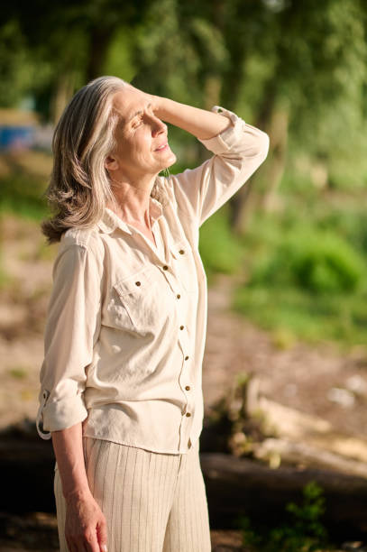 istock Woman with closed eyes standing in sun 1333500838