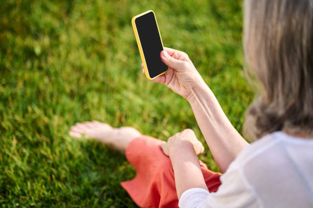 istock Woman looking at smartphone screen with interest 1333500871