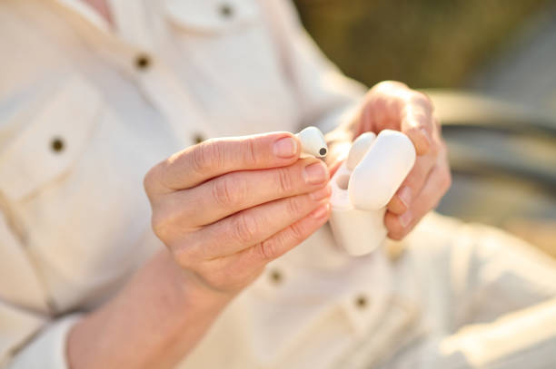 istock Female hands holding headphones and case 1333500931